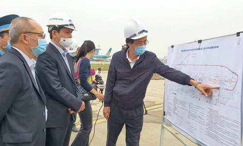 Thứ trưởng Bộ GTVT Lê Anh Tuấn nghe báo cáo tiến độ dự án sửa chữa nâng cấp đường băng, đường lăn sân bay Nội Bài giai đoạn 2 (Chụp ngày 19/2)