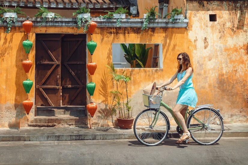 young-woman-tourist-blue-short-dress-rides-bicycle-along-street-vietnamese-tourist-city-hoi-cycling-through-old-town-hoi_161475-37.jpeg