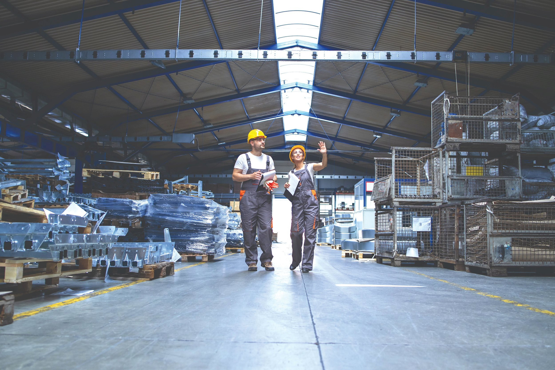 factory-workers-walking-through-large-production-hall-compressed.jpg