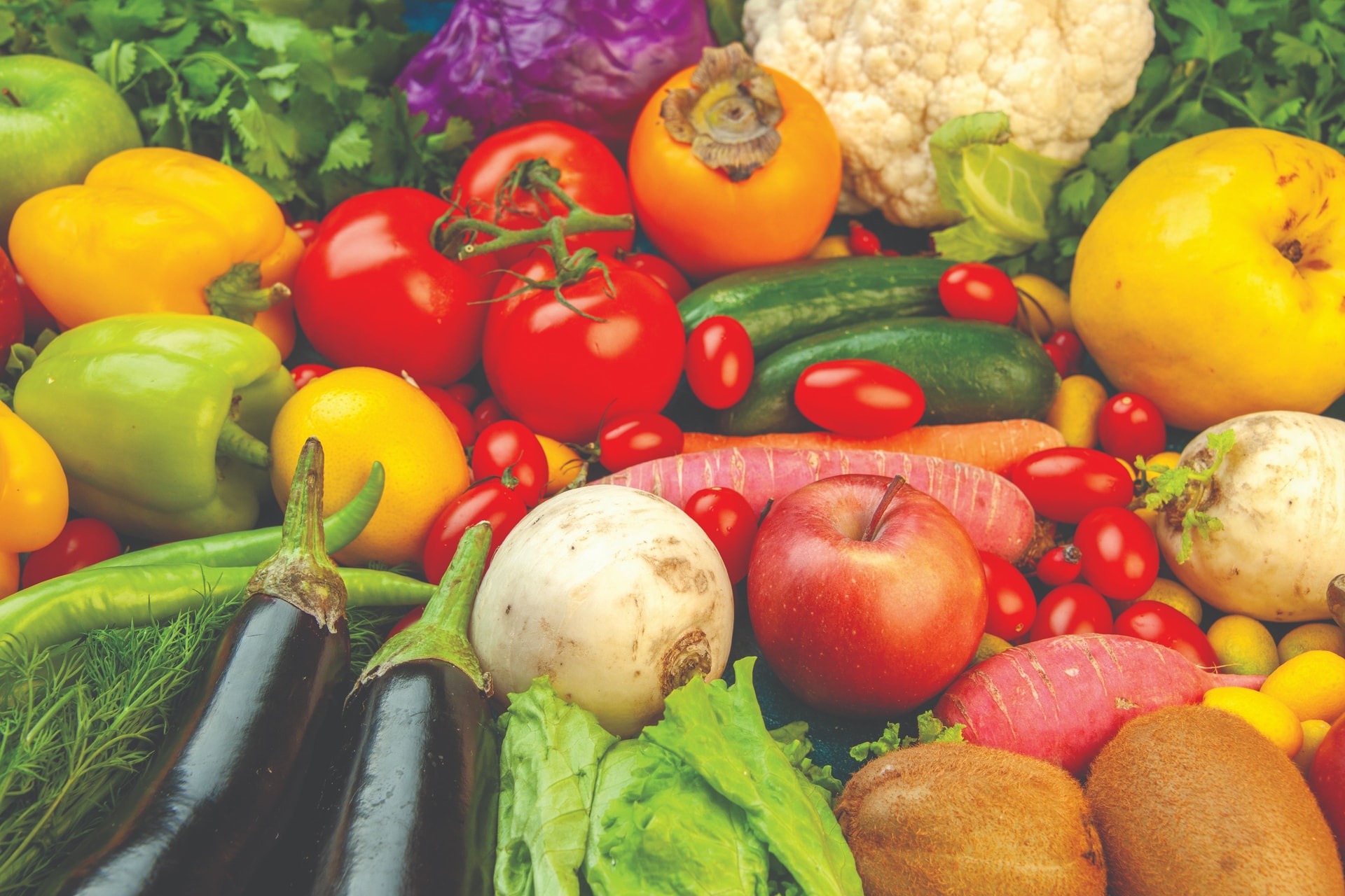 bottom-view-fruits-vegetables-radish-cherry-tomatoes-persimmon-tomatoes-kiwi-cucumber-apples-red-cabbage-parsley-quince-aubergines-blue-table-compressed.jpg