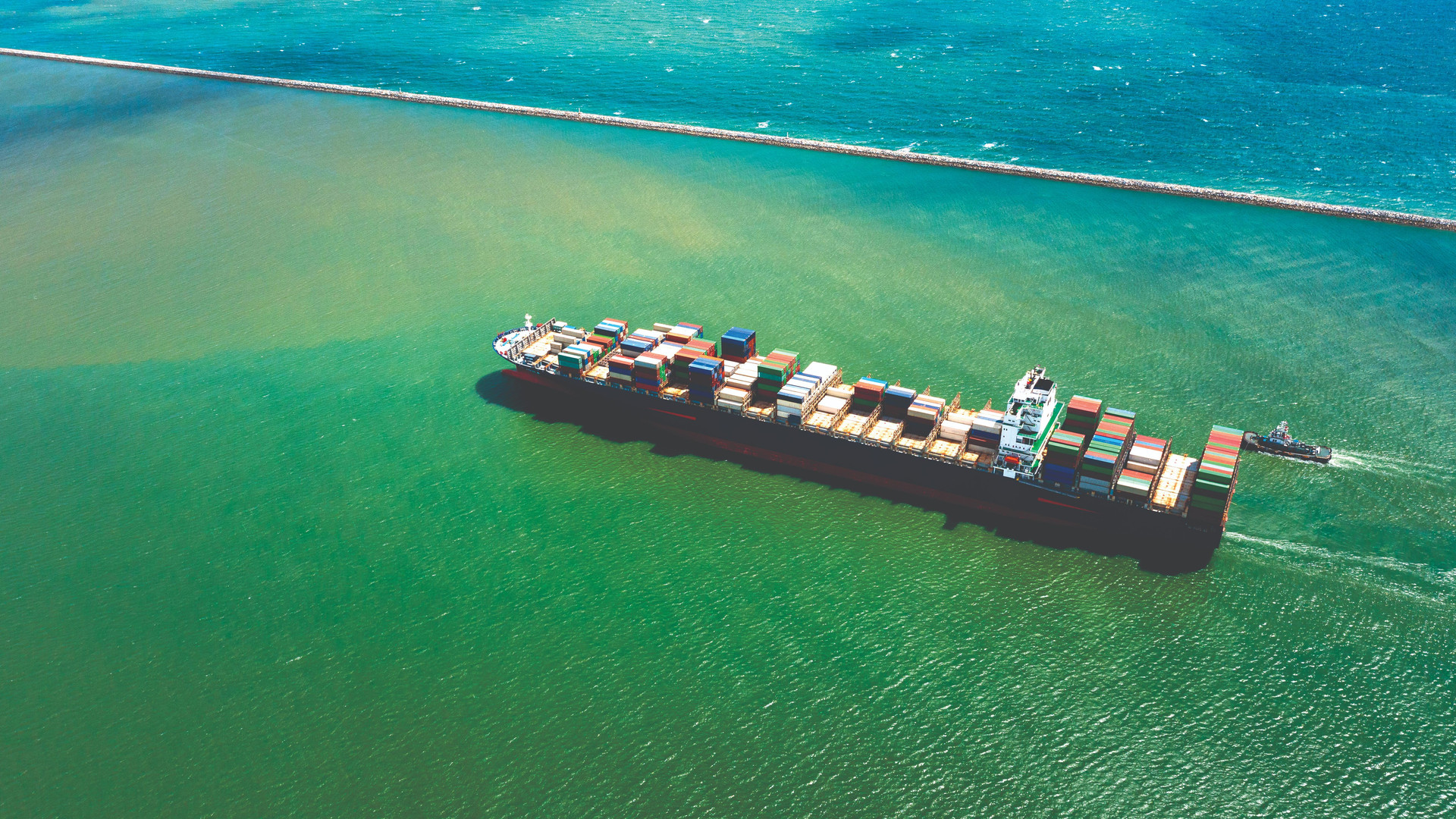 container-ship-export-import-business-services-logistics-shipping-cargo-harbor-transport-international-aerial-view-compressed.jpg