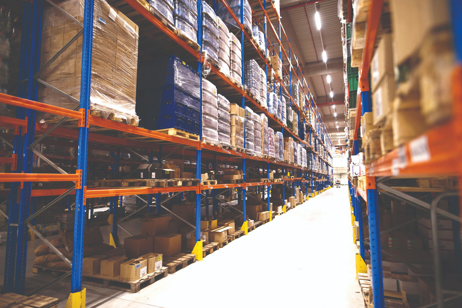interior-large-distribution-warehouse-with-shelves-stacked-with-palettes-goods-ready-market-compressed.jpg