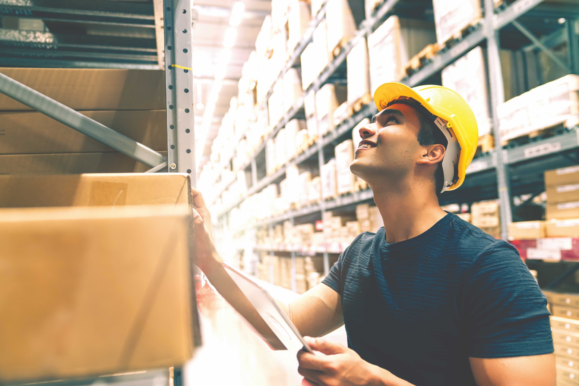 smart-indian-engineer-man-wearing-safety-helmet-doing-stock-tick-check-cardboard-stock-product-management-factory-warehouse-background-compressed.jpg