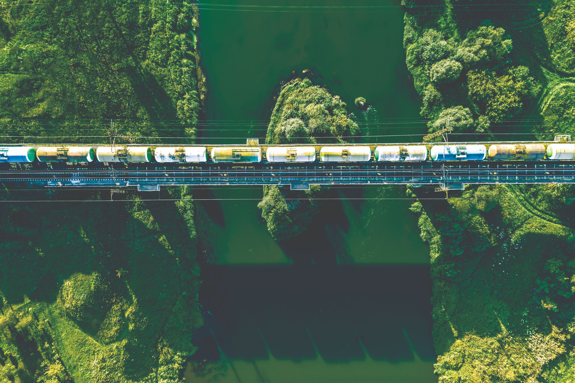 aerial-view-railway-railroad-tracks-cargo-train-river-compressed.jpg