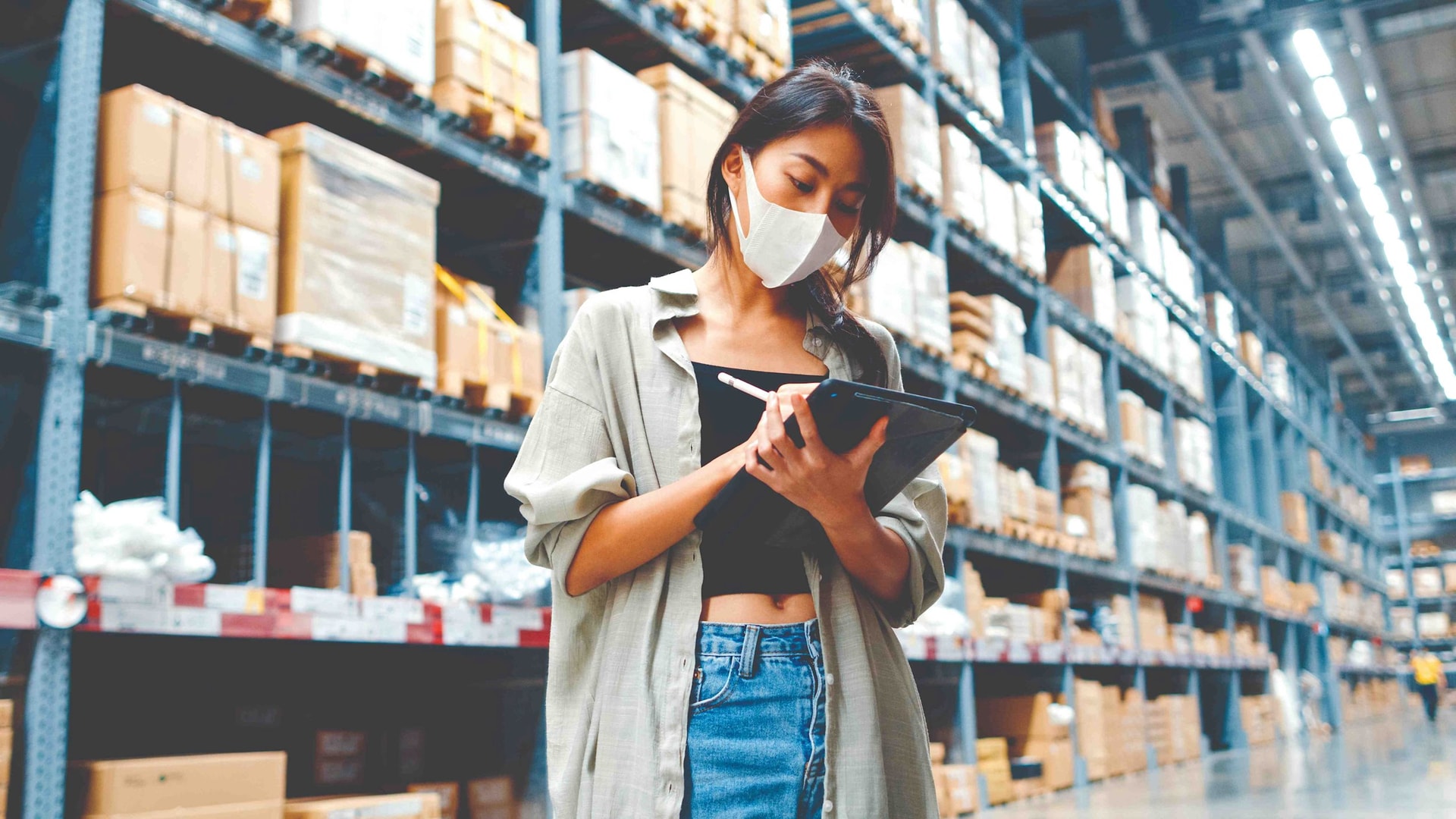 young-asian-businesswoman-manager-wearing-face-mask-warehouse-using-digital-tablet-checking-inventory-compressed.jpg