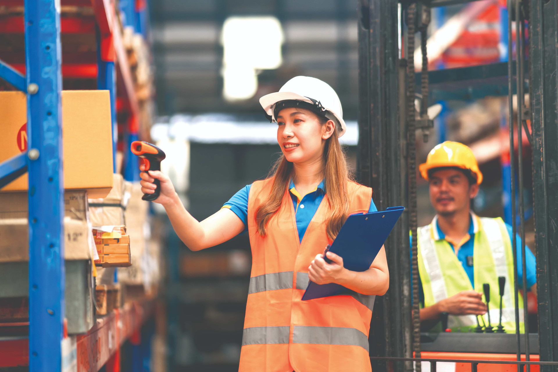 young-asian-woman-worker-using-barcode-scanner-checking-goods-box-shelf-stock-warehouse-factory-store-smile-happy-coworker-man-drive-forklift-back-warehouse-logistic-concept-compressed.jpeg