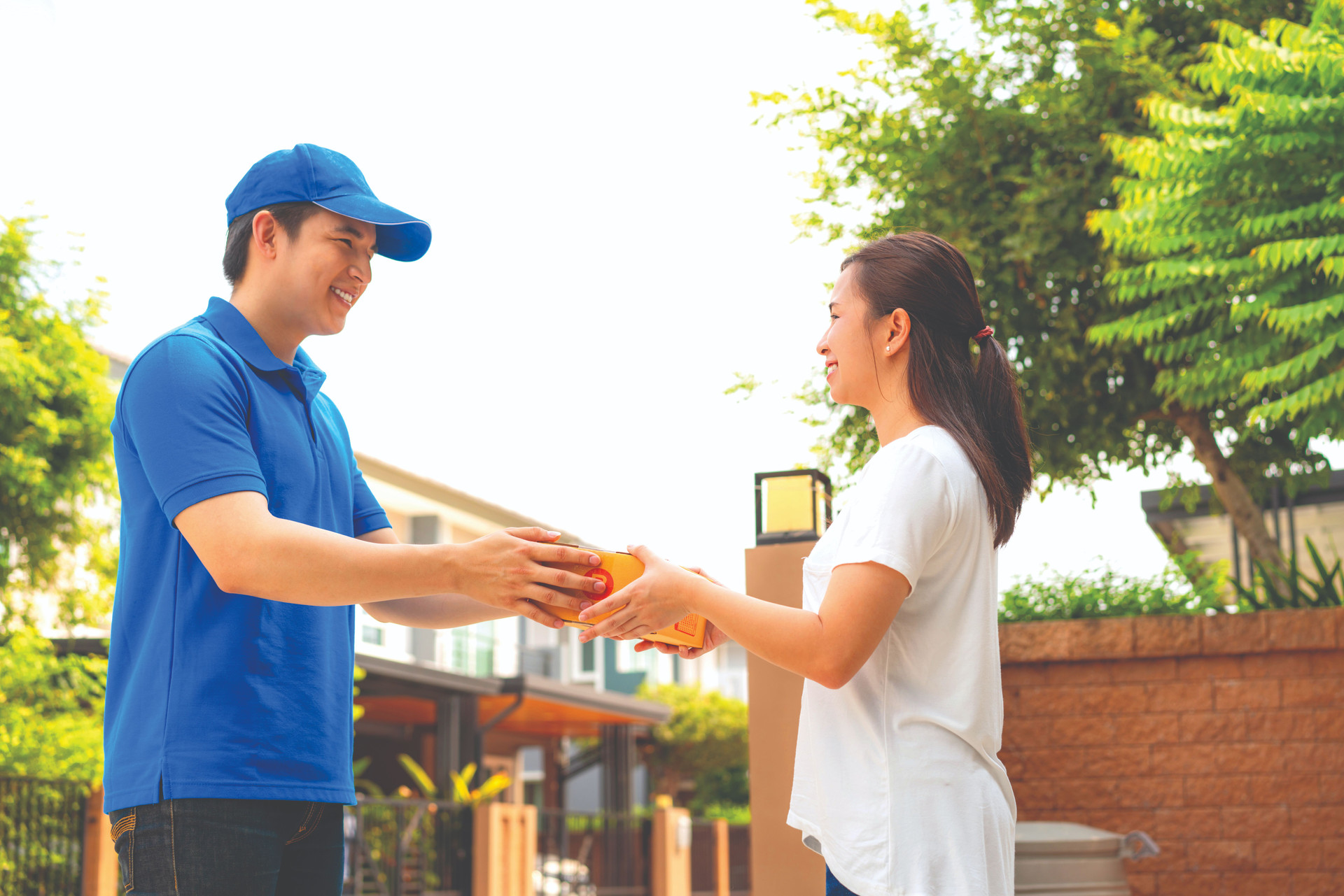 asian-delivery-young-man-blue-uniform-giving-box-customer-compressed.jpeg