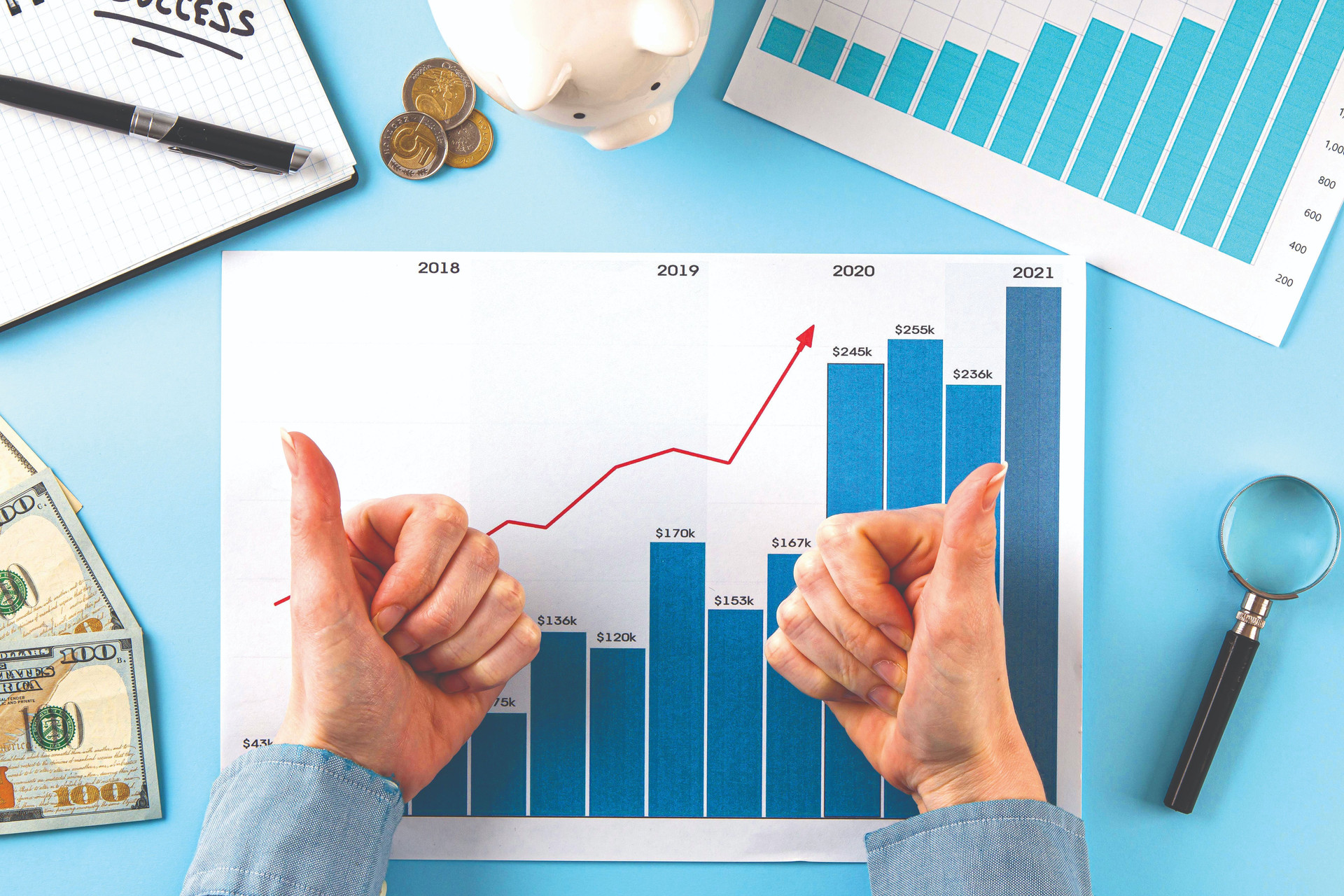 top-view-business-items-with-growth-chart-hands-giving-thumbs-up-compressed.jpeg
