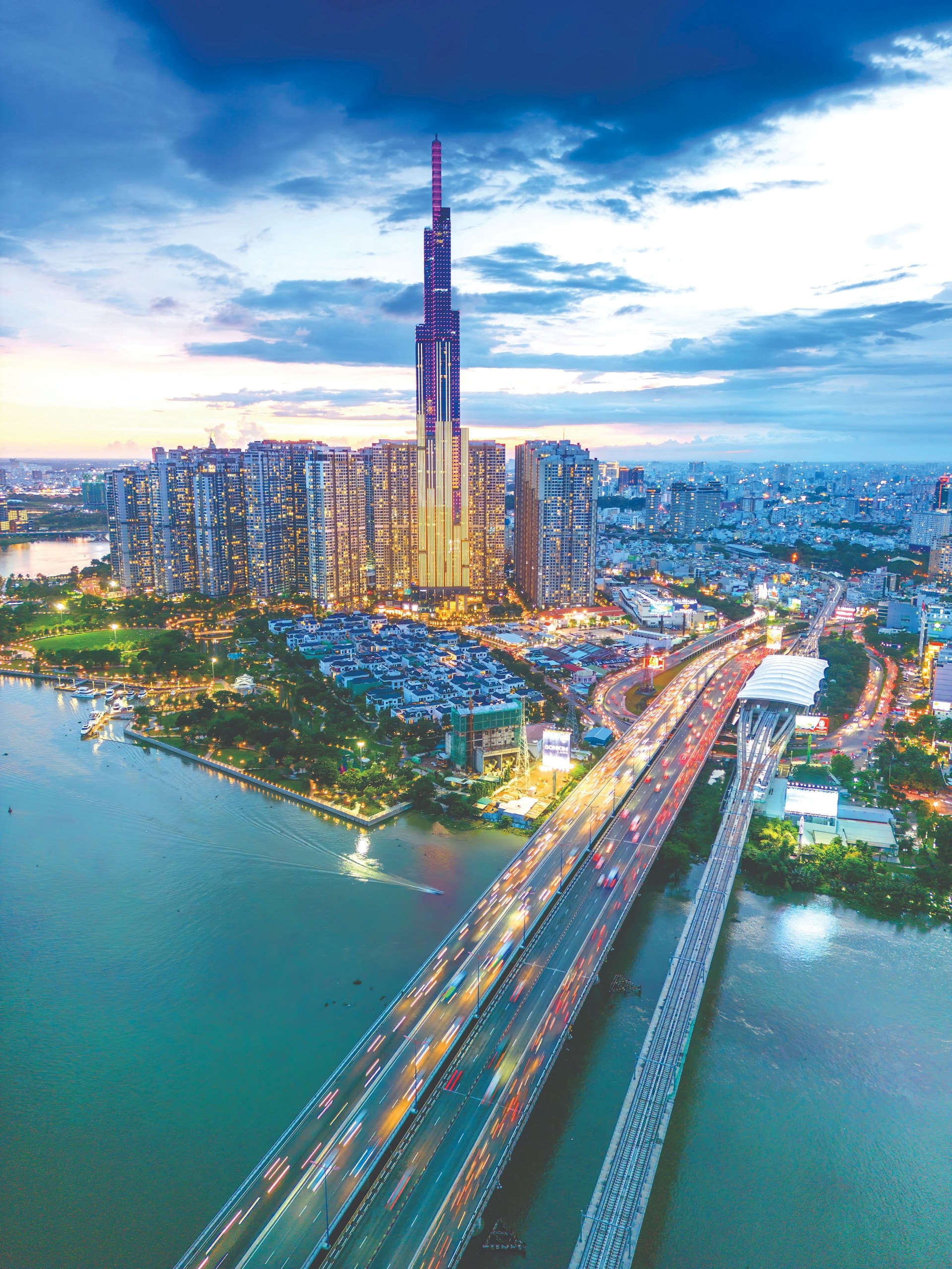 aerial-sunset-view-landmark-81-it-is-super-tall-skyscraper-saigon-bridge-with-development-buildings-along-saigon-river-light-smooth-down-saigon-skyline-compressed.jpeg