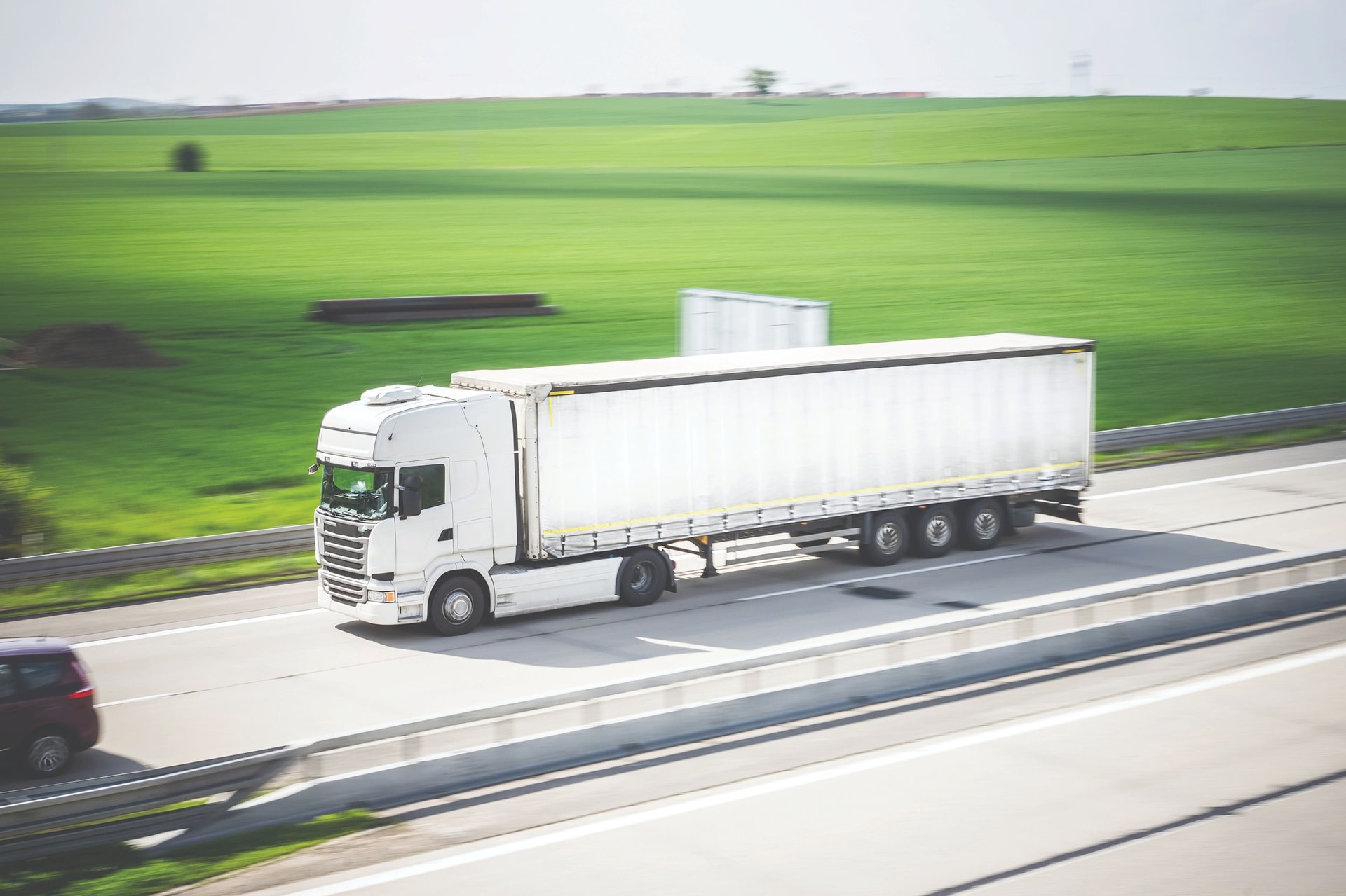 white-tir-truck-in-motion-driving-on-highway-picjumbo-com-compressed.jpeg