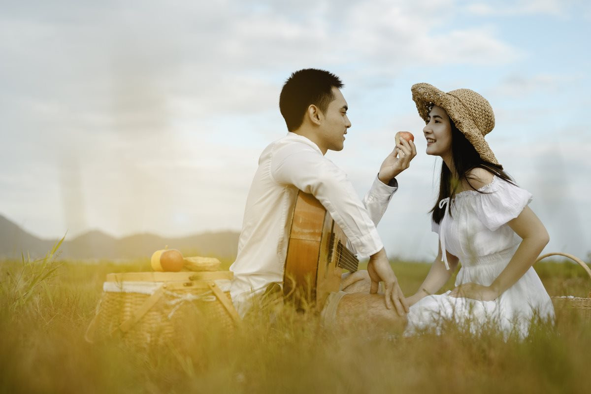 happy-lovers-sitting-grassland-looking-each-other-with-tenderness-men-have-guitars-give-apples-women-they-look-each-other-with-love-smiles-1-.jpg