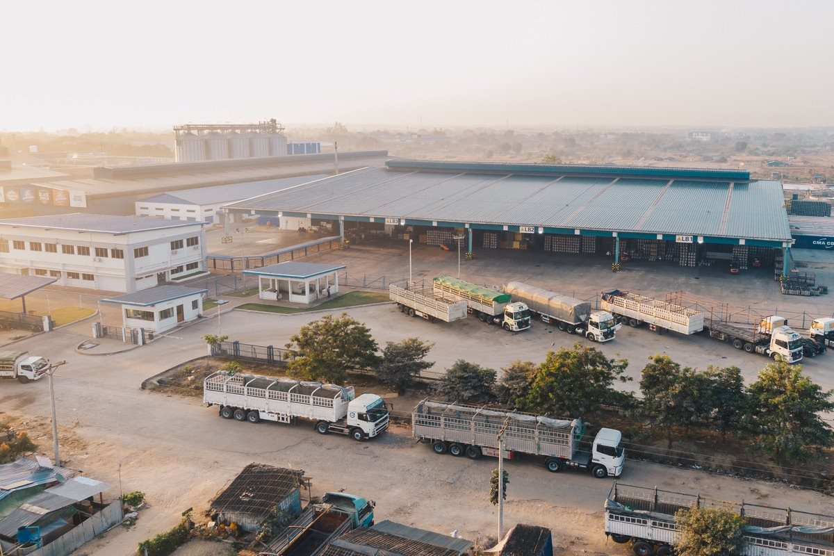 aerial-view-factory-trucks-parked-near-warehouse-daytime-1-.jpg