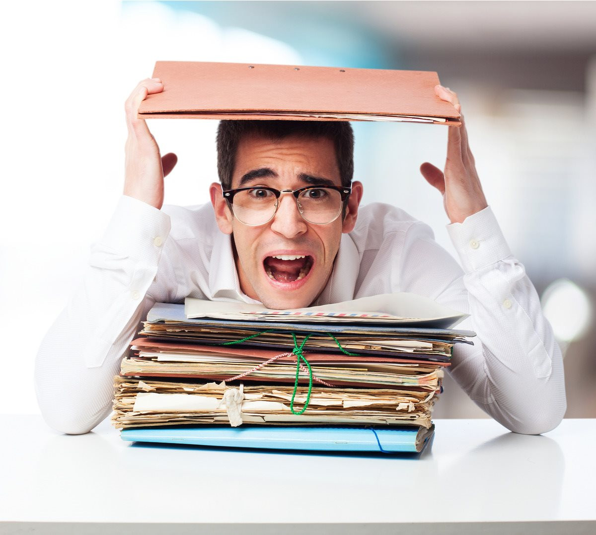 stressed-man-looking-mountain-folders-screaming-1-.jpg