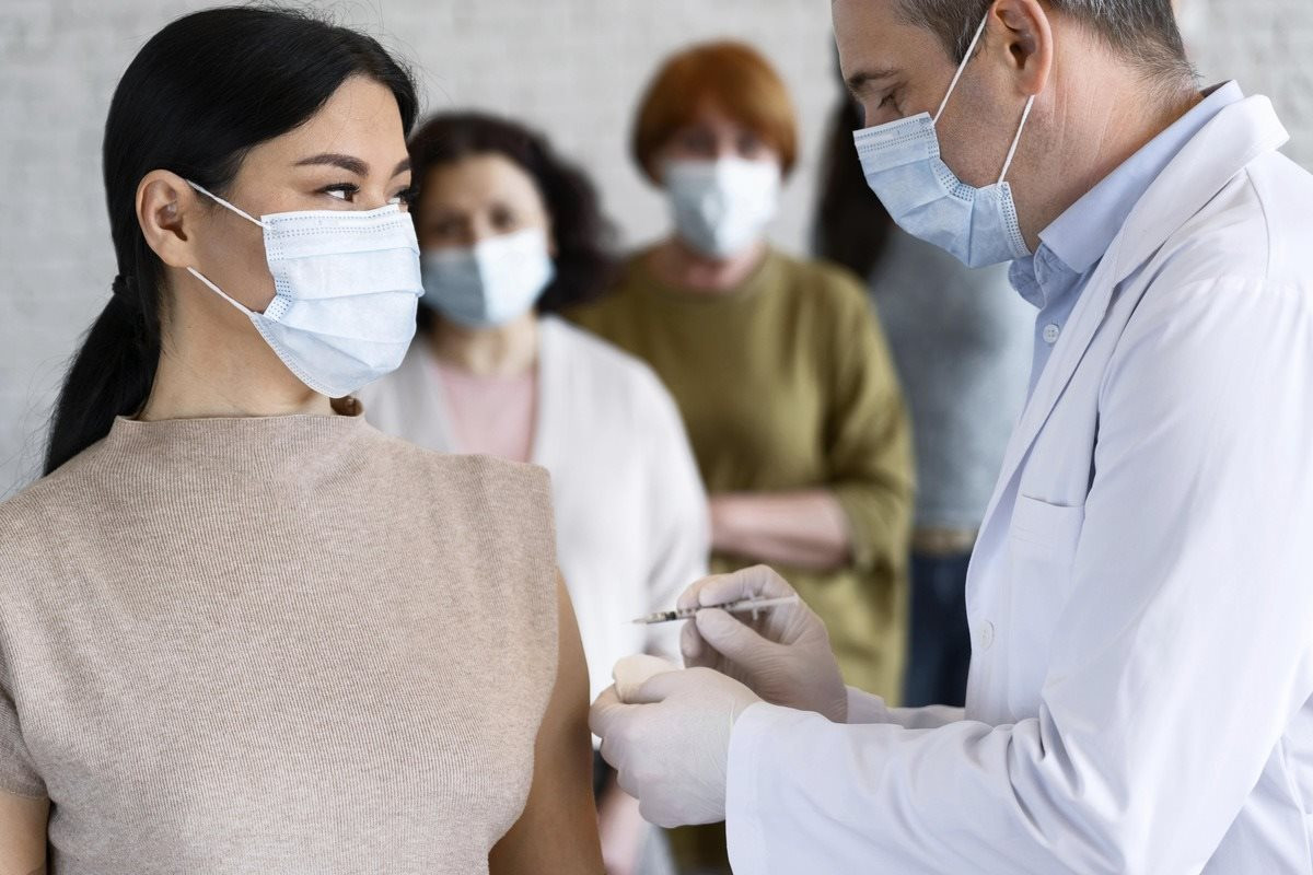 woman-getting-vaccine-shot-by-doctor-with-medical-mask-1-.jpg